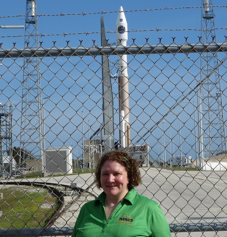 woman outdoors with rocket in background